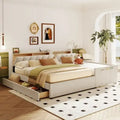 Lit plateforme capitonné beige avec tiroirs de rangement et étagères de tête de lit